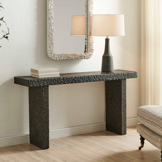 console table made of textured stone on a white background