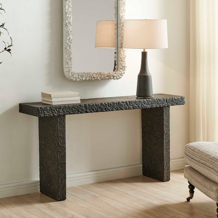 console table made of textured stone on a white background