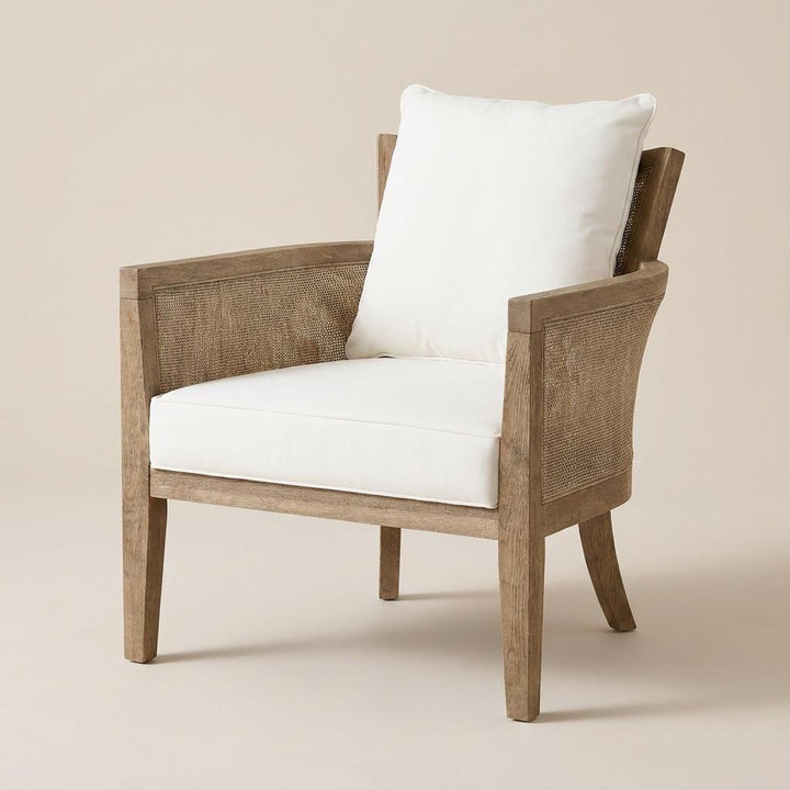 Wooden armchair with white cushions on a beige background