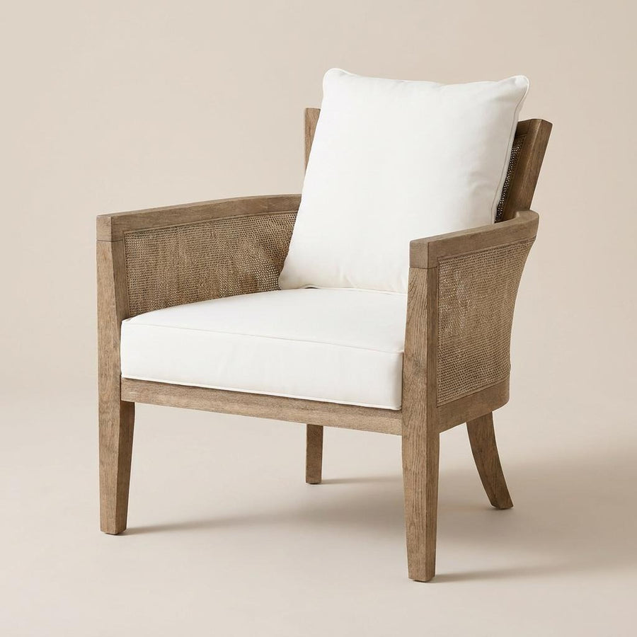 Wooden armchair with white cushions on a beige background