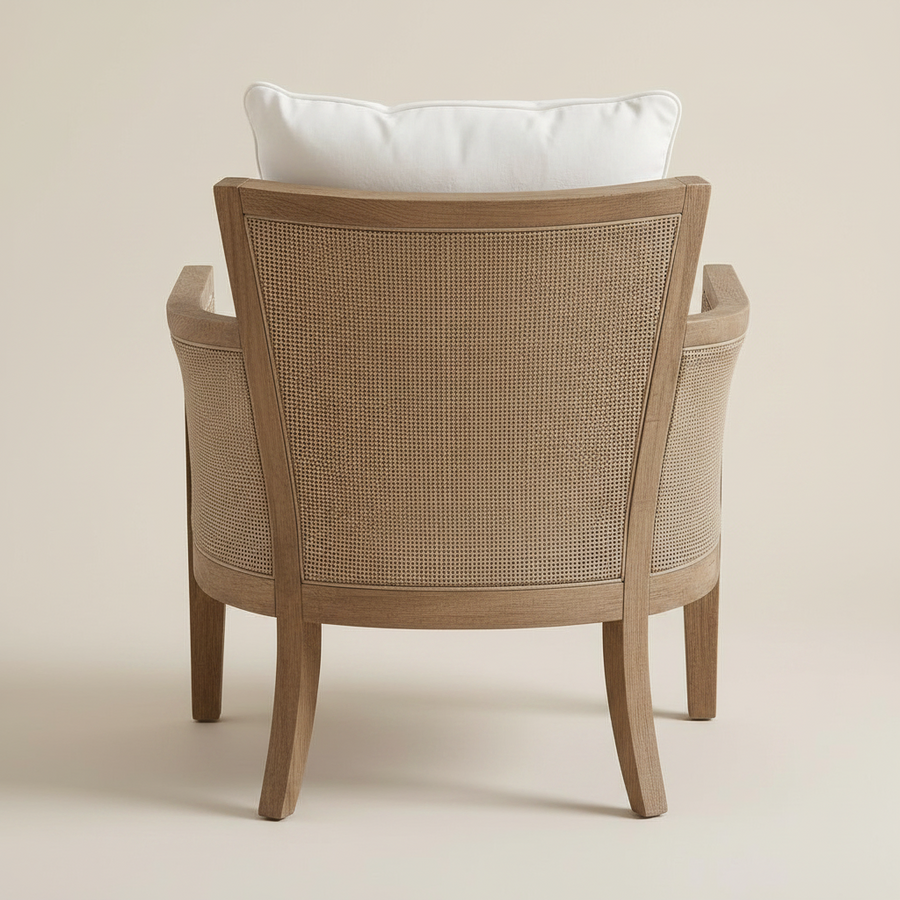 Wooden armchair with woven backrest and white cushion on a beige background