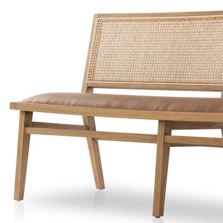 A stylish wooden bench featuring a cane backrest and a padded brown seat, highlighting modern design and natural materials.