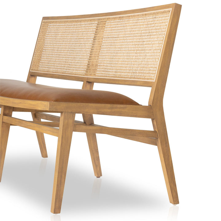 Stylish wooden bench with a woven cane backrest and a brown cushioned seat.