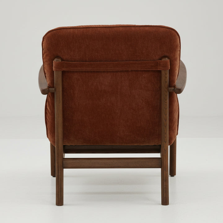 brown velvet upholstered armchair with wooden frame on a white background