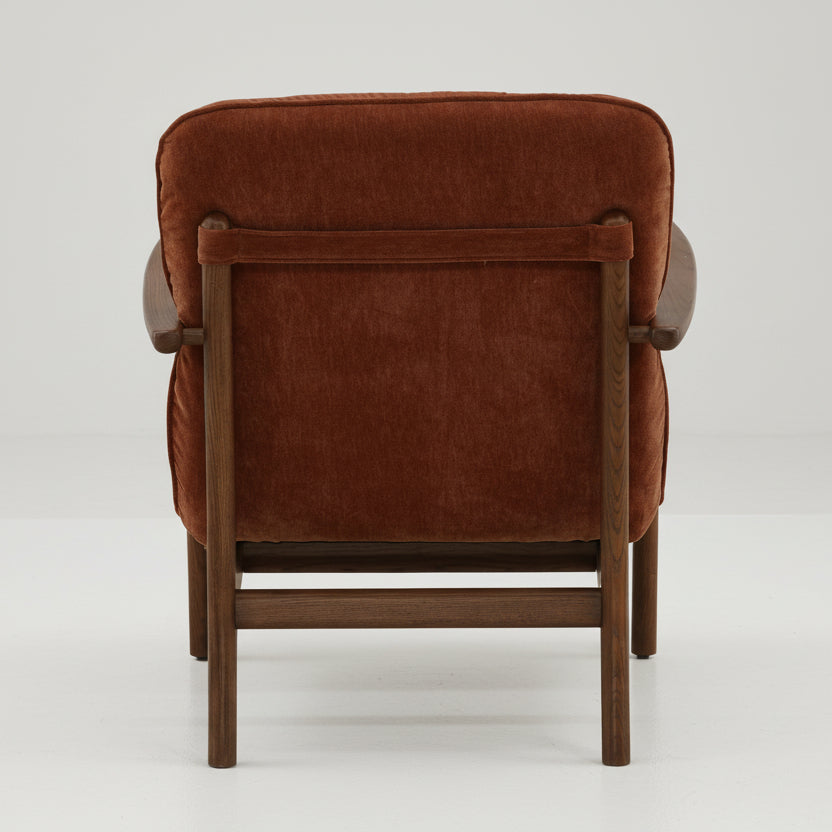 brown velvet upholstered armchair with wooden frame on a white background