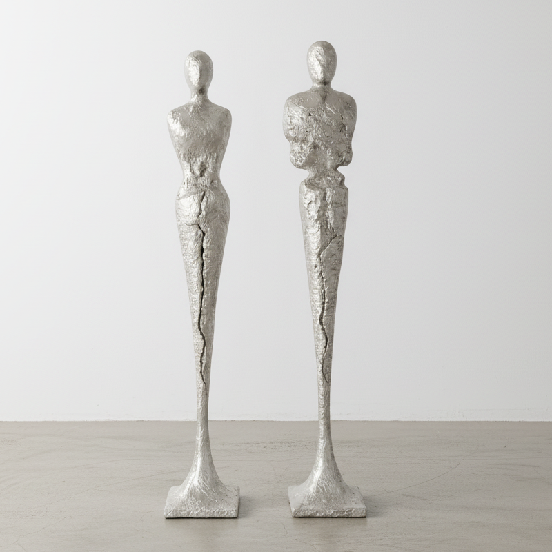 TALL CHISELED SILVER LEAF MALE & FEMALE SCULPTURES