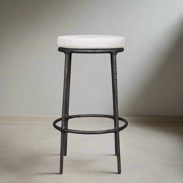 Bar stool with white cushioned seat and black metal frame on a white background