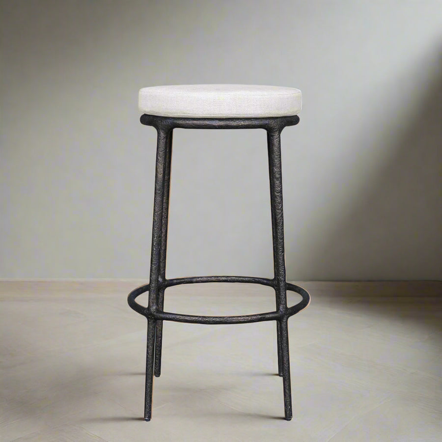 Bar stool with white cushioned seat and black metal frame on a white background