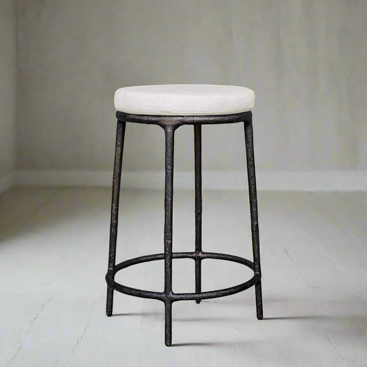 Bar stool with white cushioned seat and black metal frame on a white background