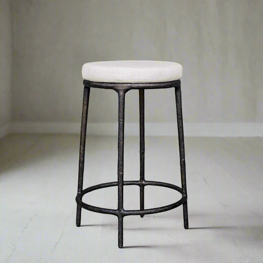 Bar stool with white cushioned seat and black metal frame on a white background