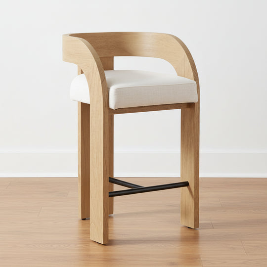 Wooden bar stool with white cushion on a wooden floor and light background