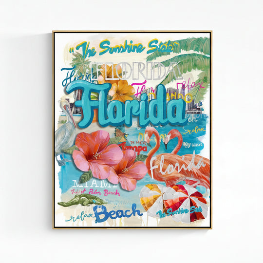 A gold framed Florida-themed art print featuring colorful typography, palm leaves, hibiscus flowers, flamingos, beach umbrellas, and tropical scenery on a white wall.