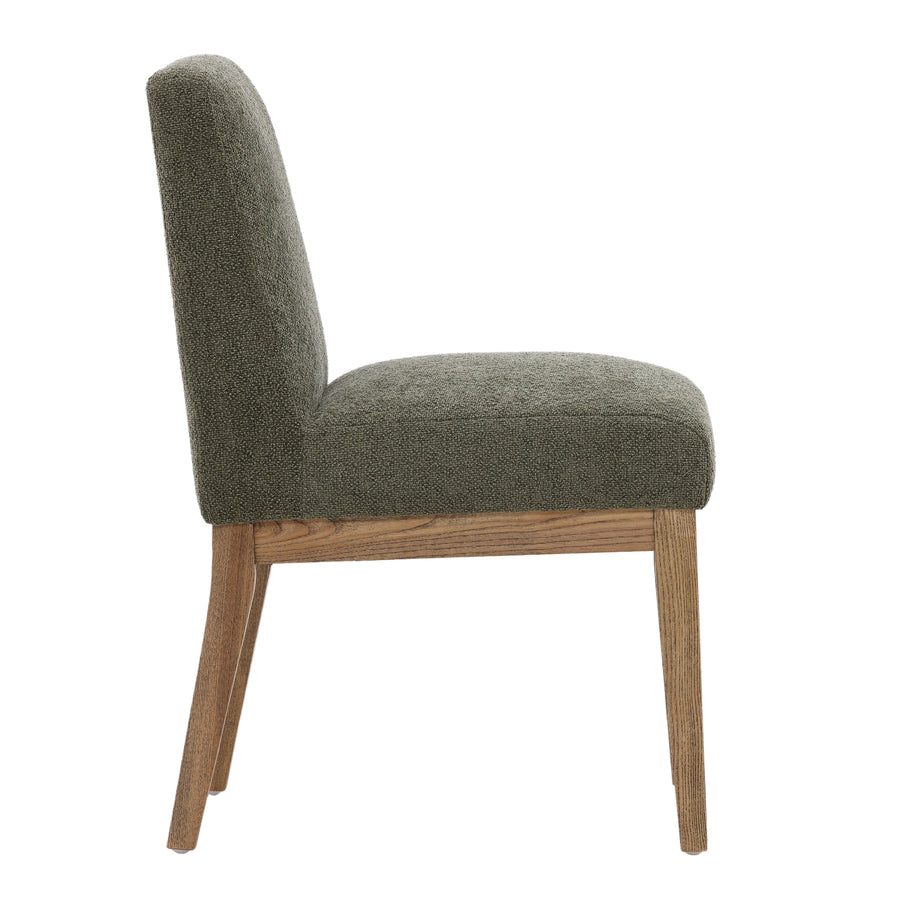 Green upholstered chair with wooden legs on a white background