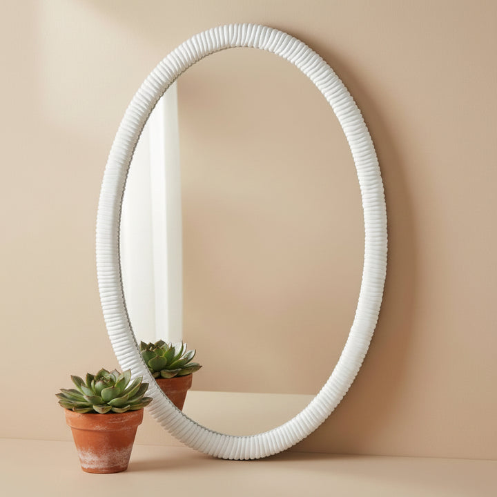 White oval mirror with ribbed frame