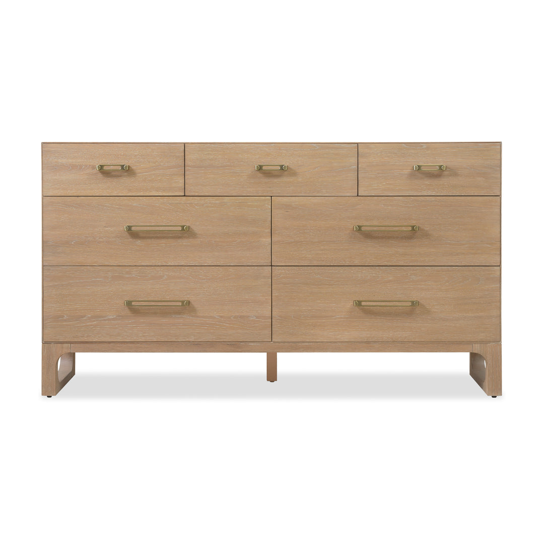 Front view of a wooden dresser with a light oak finish, 7 drawers, and brass handles against white background.