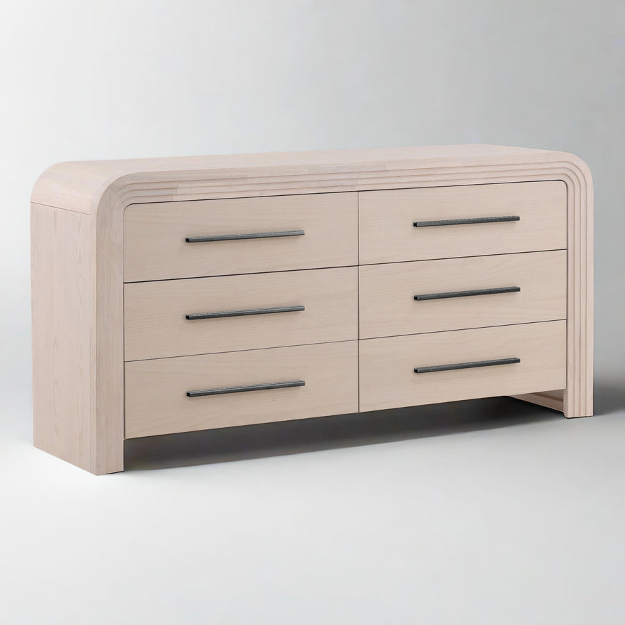 Light wood dresser with rounded edges, featuring six drawers with sleek metal handle.