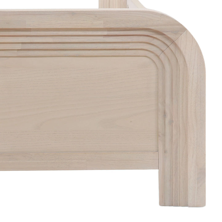 Close-up of a light wood furniture piece with smooth, rounded edges and subtle horizontal grooves along the top edge.