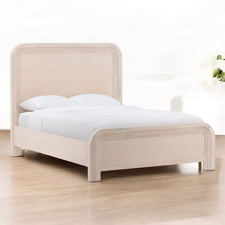 White wooden panel bed with a classic design, set in a stylish bedroom decor.