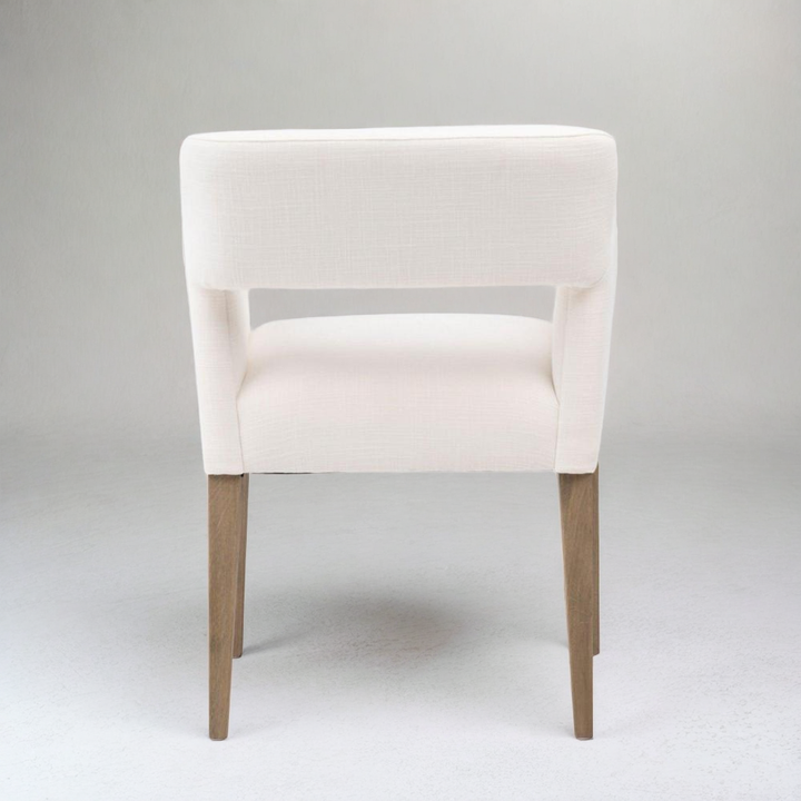 White chair with wooden legs on a gray background