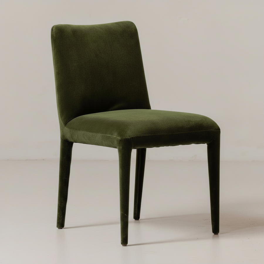 Green velvet chair on a light background