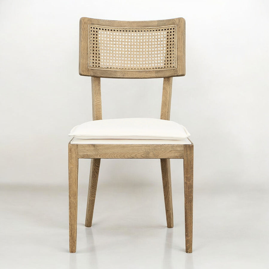 Front view of a wooden dining chair with a light cushion.