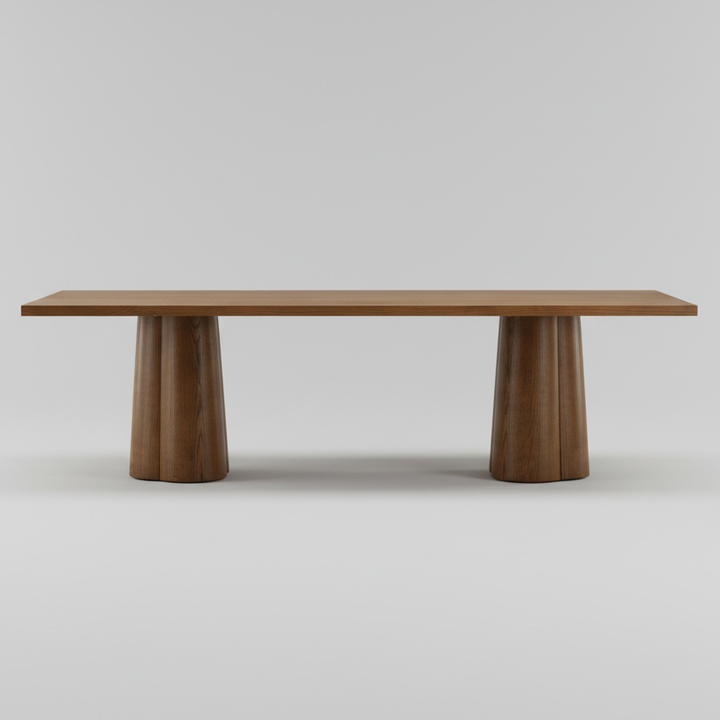 A minimalist wooden table with a rectangular top and two fluted pedestal legs, shown against a neutral light gray background.