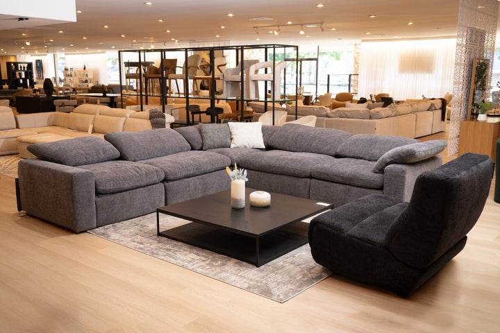 Modern living room with a sleek sofa, cozy cushions, and elegant decor.