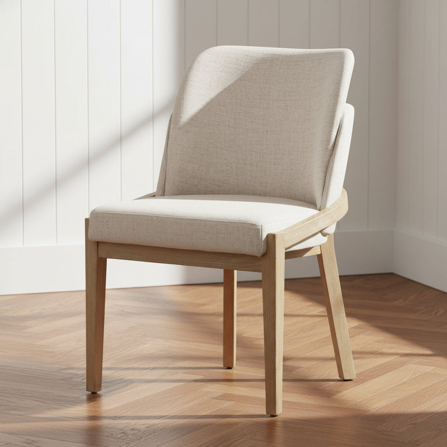 Beige chair with wooden frame on a wooden floor