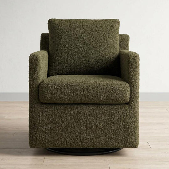 Green textured armchair on a wooden floor with a white wall background
