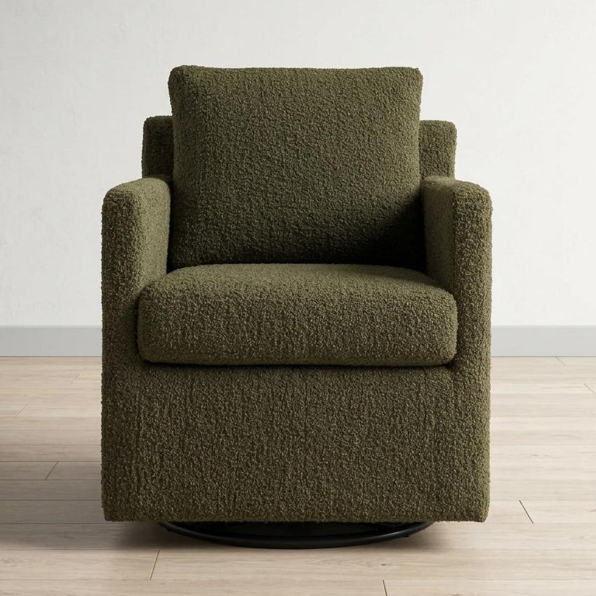 Green textured armchair on a wooden floor with a white wall background