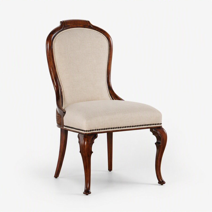 A classic wooden dining chair with a curved backrest, upholstered in beige fabric, featuring curved cabriole legs and decorative nailhead trim on the seat.