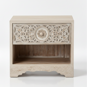 Wooden nightstand, whitewashed finish, intricate floral carvings on drawer front, central circular motif, open shelf below, scalloped base, rustic vintage style