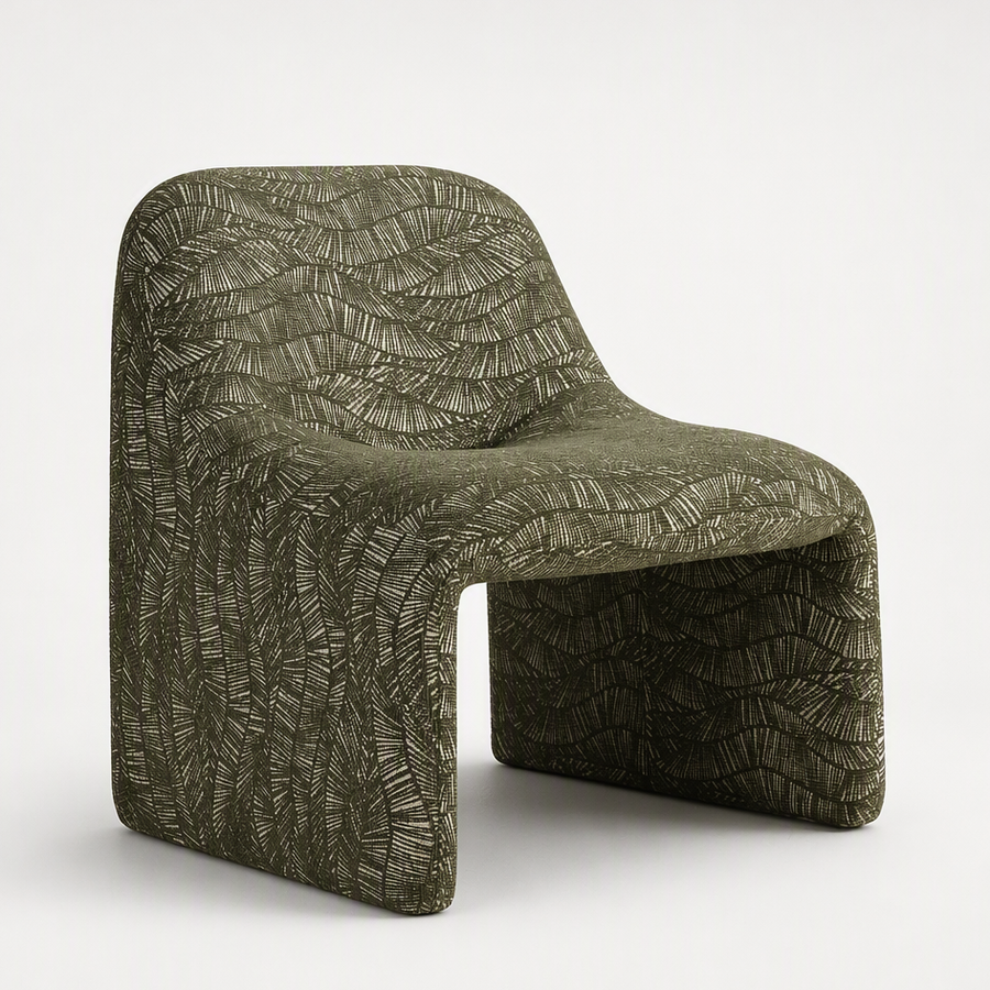 A sculptural molded chair upholstered in textured olive green fabric with a raised leaf-like pattern, shown on a clean white studio background.