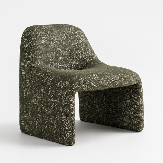 A sculptural molded chair upholstered in textured olive green fabric with a raised leaf-like pattern, shown on a clean white studio background.