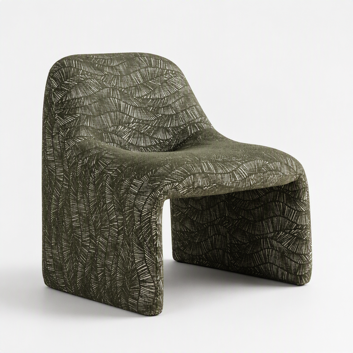 A sculptural molded chair upholstered in textured olive green fabric with a raised leaf-like pattern, shown on a clean white studio background.