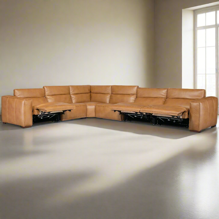 An L-shaped brown leather sectional sofa with reclining sections, set against a light-colored wall and large window.