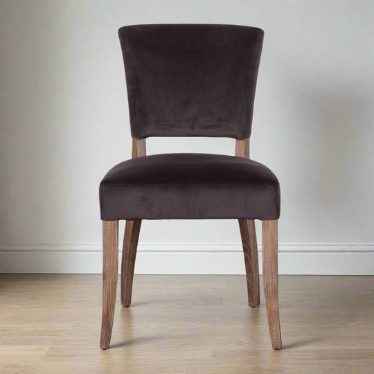 Brown upholstered chair with wooden legs on a white background