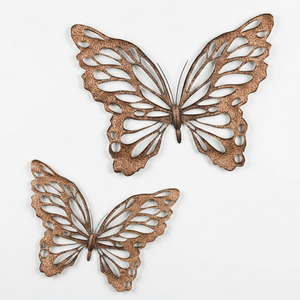 Two copper butterfly wall art pieces on a white background