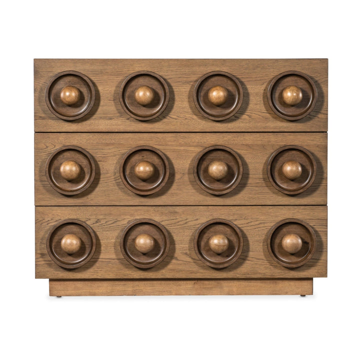 Wooden drawer chest with a geometric design featuring three rows of circular, recessed patterns and spherical knobs.