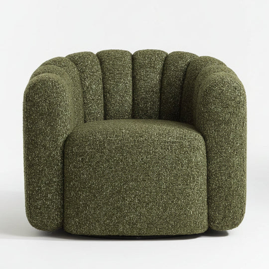 Green textured armchair on a wooden floor with a neutral background