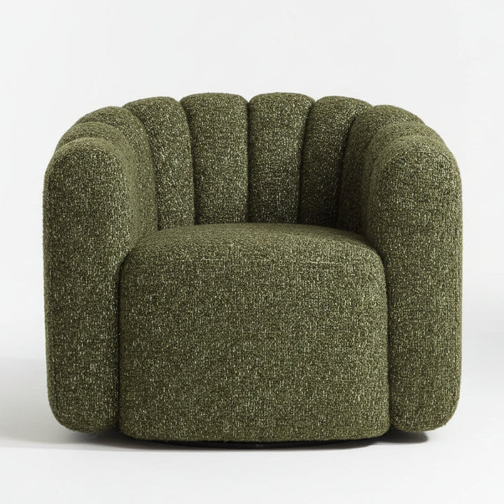 Green textured armchair on a wooden floor with a neutral background