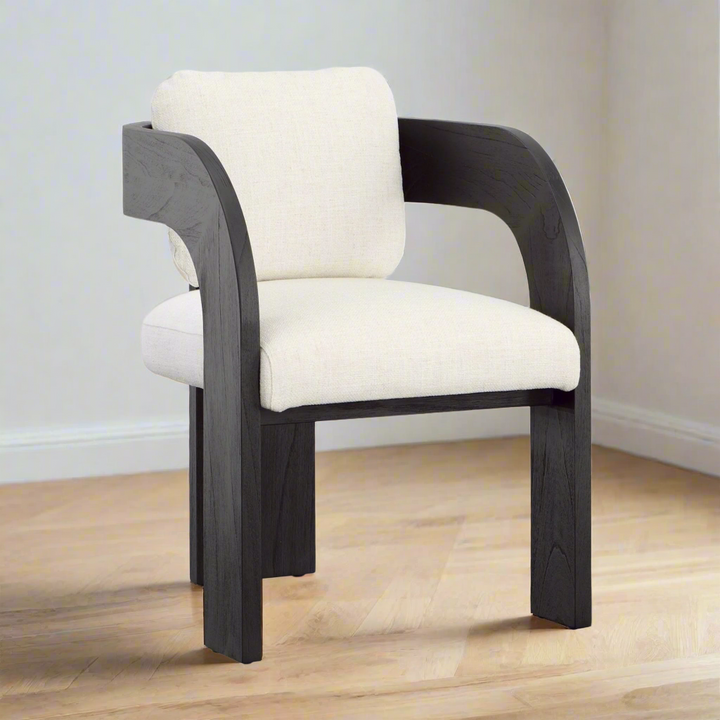 Chair with black frame and white cushion on a wooden floor.
