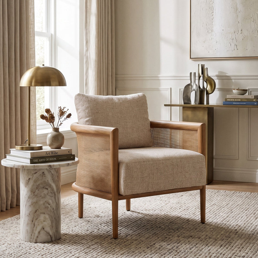 Odette Cane Paneled Accent Chair in a neutral, sunlit living room with a marble side table and elegant decor.