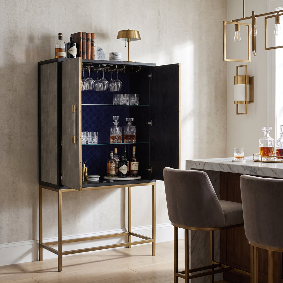 Mako Shagreen Tall Bar Cabinet featuring a gold frame and navy interior, styled in a modern, elegant home bar setting.