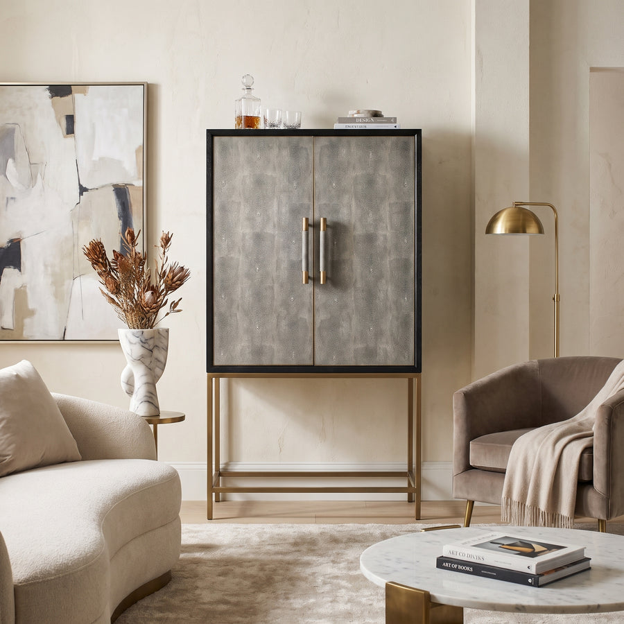 Modern living room featuring a textured grey bar cabinet, marble accents, and a plush cream sofa in a sophisticated style.