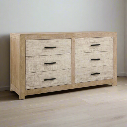 Wooden dresser with multiple drawers on a wooden floor.