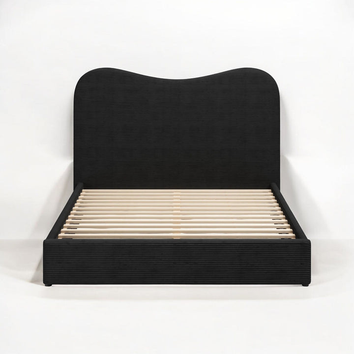 Black upholstered bed frame on a white background