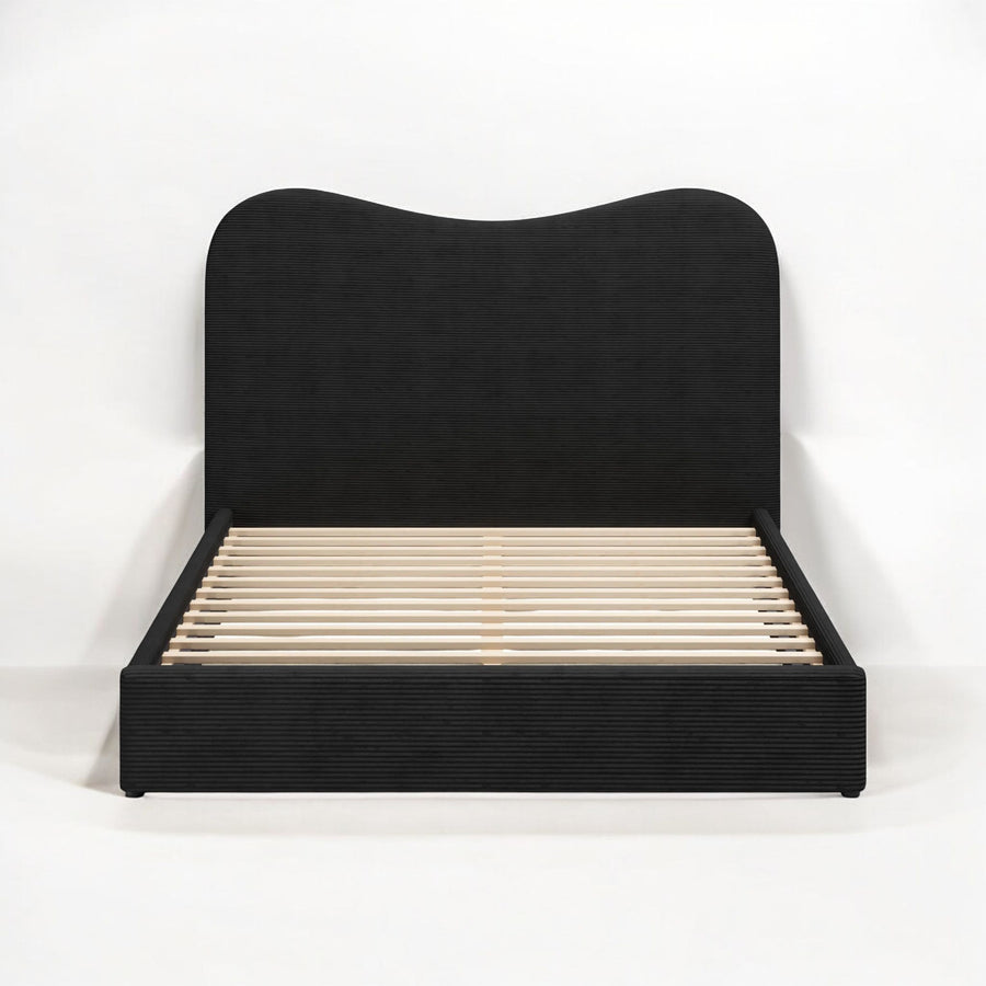 Black upholstered bed frame on a white background