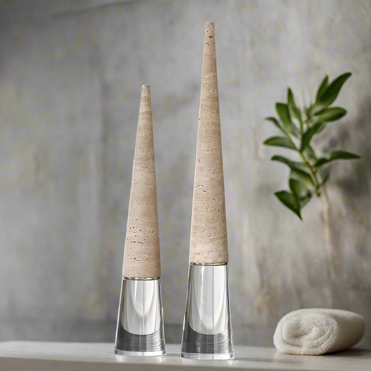 Two tall, cone-shaped vases with beige tops and clear bases on a neutral background.