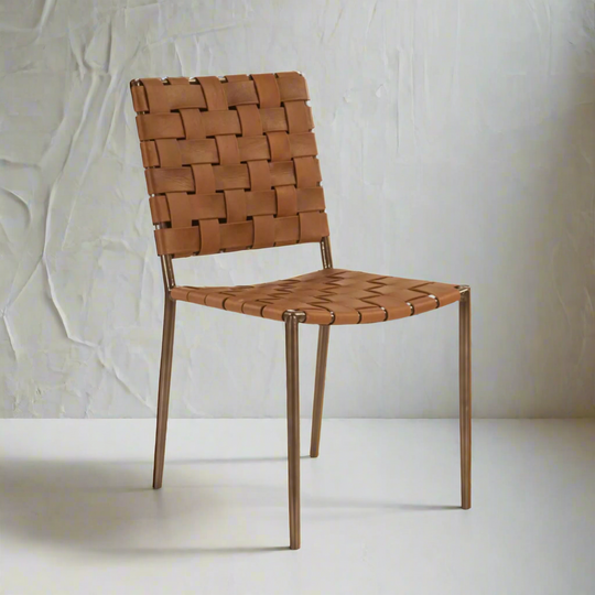 Light Brown woven chair on a white floor with a white wall background